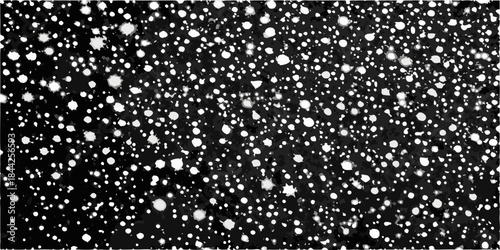 A monochrome image displaying a dense scattered pattern of white specks on black