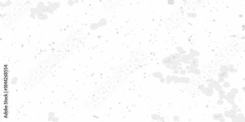 A white grainy texture with scattered dark speckles and blurred shapes