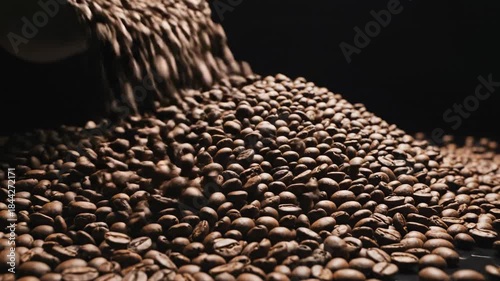 Dramatic close-up view of a shaking pile of dark roasted coffee beans under low-key lighting, visually representing extreme market volatility and a financial crisis trade, dark, macro shot