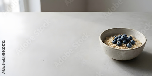 Healthy Breakfast Concept: Oatmeal with Blueberries and Vast Negative Space on Stone - AI Generated