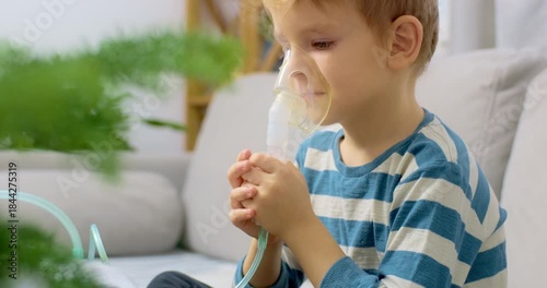 Young Boy Using Nebulizer for Respiratory Treatment at Home