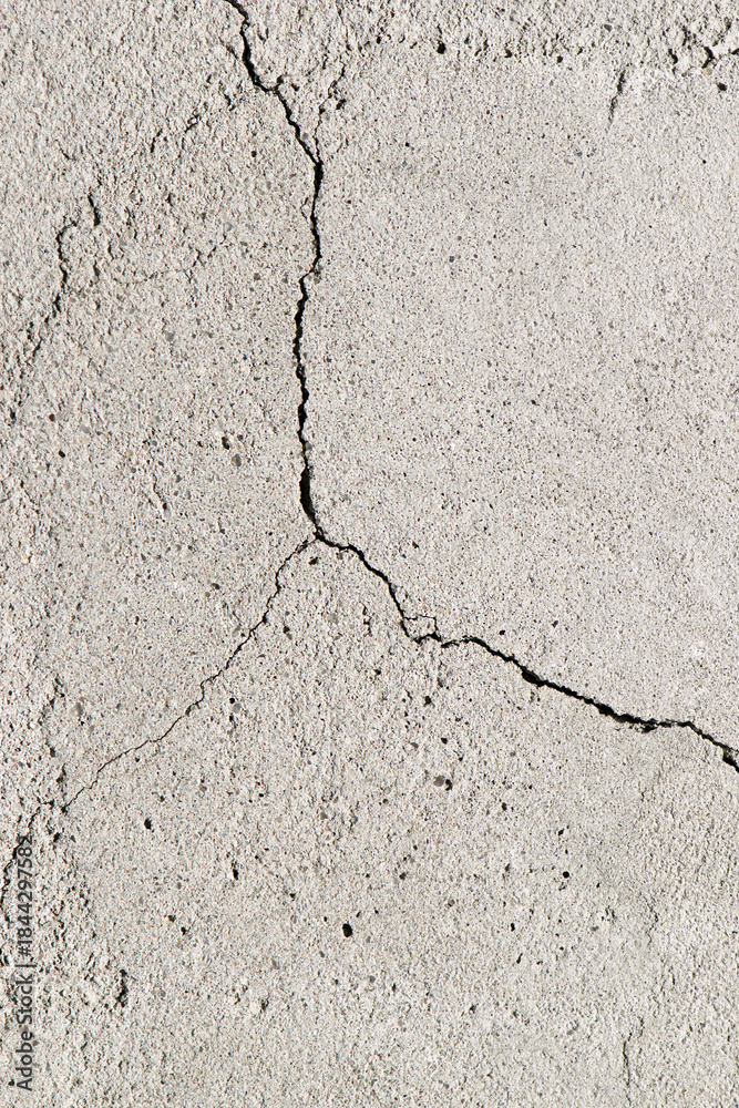 Fototapeta premium clay wall. the old clay wall is crumbling. surface wall for vintage background. Wall texture for background. old cracked plaster, grey cement floor, needs repair, restoration