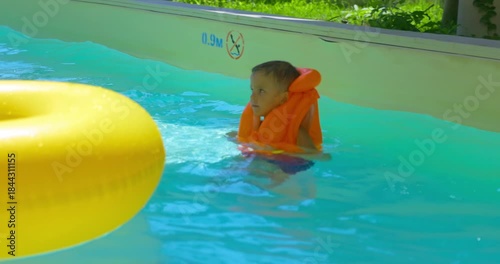 Child Enjoying Water Park Pool with Inflatable Ring