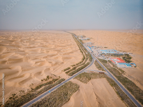 Photography Aerial view of a small oil town in the heart of the Taklamakan Desert in Xinjiang, China