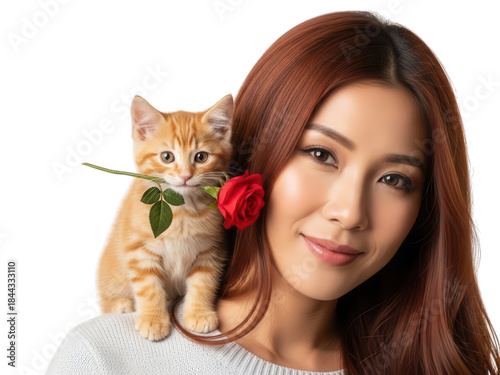 Woman with long red hair gently poses with an orange kitten and a red rose