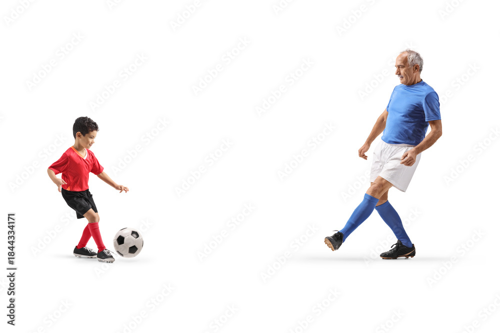 Obraz premium Mature man kicking a football with a kid
