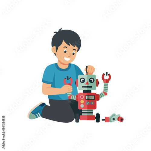 A child kneels, smiling as he works on a red and green robot