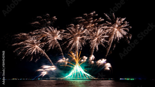 Amazing beautiful colorful firework display over sea on celebration night. Fireworks show for happy new year	