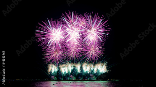 Amazing beautiful colorful firework display over sea on celebration night. Fireworks show for happy new year	
