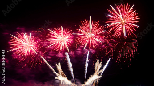 Amazing beautiful colorful firework display over sea on celebration night. Fireworks show for happy new year	