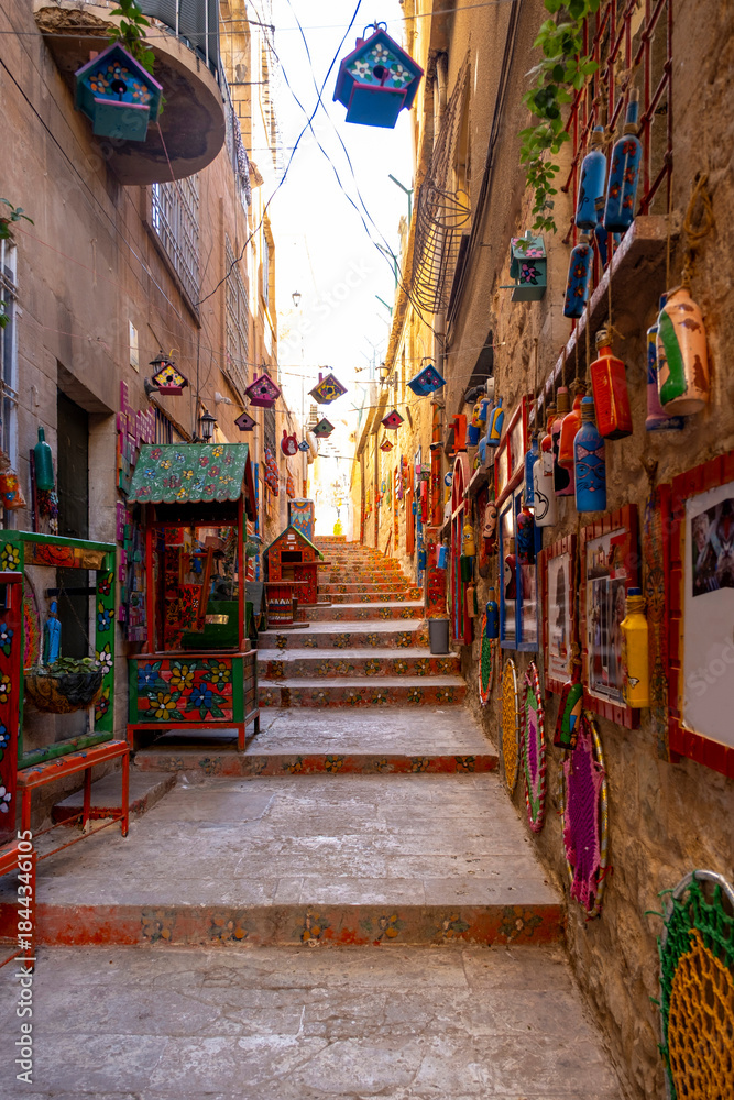 Fototapeta premium Mardin’s Medieval Old Town. Limestone buildings cascade down the rocky hill, tumbling to the Mesopotamian Plain far below. Between these heritage homes, a labyrinth of tight cobblestone lanes wind up 