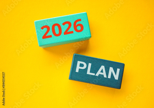 Plan 2026 Text on Wooden Blocks on a Yellow Background. New Start, Vision, Resolution, Goal, and happy New Year concept. 