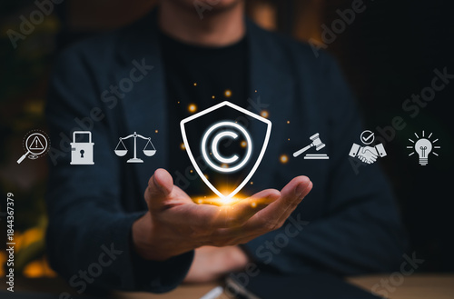 Copyright protection concept. Person holding copyright icon with legal, security, and intellectual property symbols, representing creative rights, trademark law and digital content ownership.