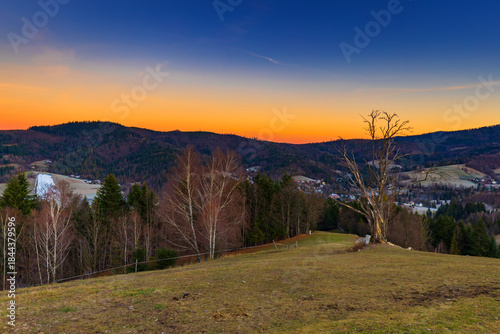 Fototapeta Naklejka Na Ścianę i Meble -  Vibrant dawn sky over hilly rural Beskid Mountains landscape, natural background or nature wallpaper, Poland