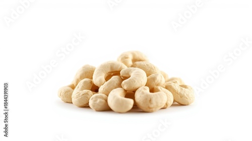 Closeup of raw cashews arranged in a small neat pile on white background, showcasing their creamy texture and natural curves, ideal for food and snack concepts