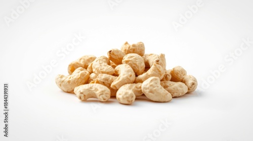 Closeup of raw cashews arranged in a small neat pile on white background, gourmet food ingredients