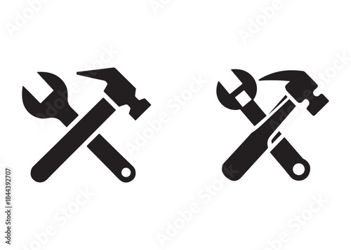 hammer and wrench logo silhouette vector, hand tool logo silhouette illustration, construction equipment logo, repair service wrench crossed over a hammer logo silhouettes vector on white background 