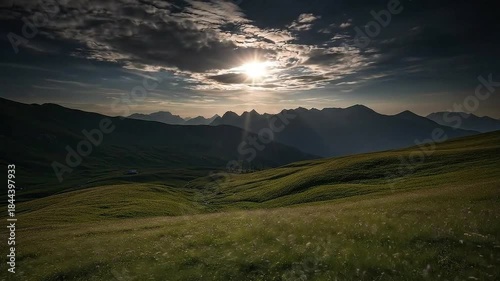 Dramatic Mountain Landscape at Sunset with Sunbeams Breaking Through Clouds.