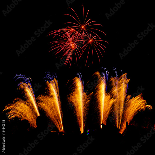 Photos Colorful fireworks display exploding in dark night sky, festive celebration background with copy space