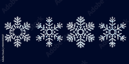 A collection of delicate intricately designed snowflakes against a dark background