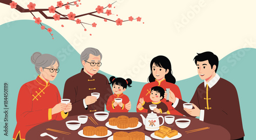 Happy multi-generational Asian family in traditional clothing enjoying tea and mooncakes together for the Mid-Autumn Festival.