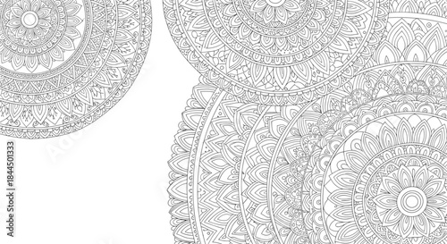 Black and white background with large, intricate mandala patterns and copy space in the corner, ideal for coloring or design.