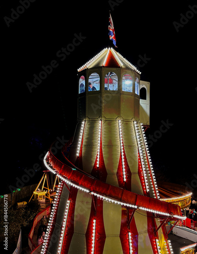 Illuminated Helter-Skelter in a fairgound.  Taken in low light and from elevated position