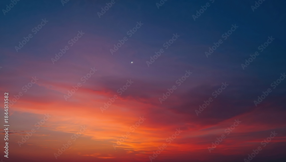 Fototapeta premium Vivid gradient sunset sky transitioning from warm orange to deep purple, perfect for backgrounds and design.