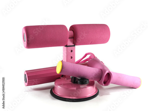 A close-up shot of a modern pink sit-up bar offers a sleek, ergonomic design for effective core workouts. Showcasing its padded rollers and adjustable features.