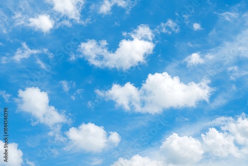 Beautiful blue sky with fluffy white cumulus and wispy cirrus clouds, isolated on white background