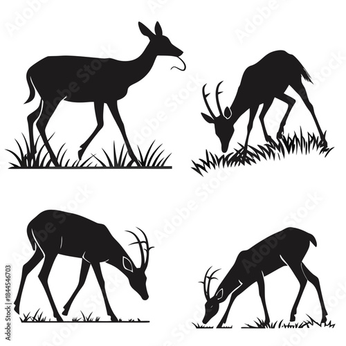 Four black silhouettes of deer and antelope grazing