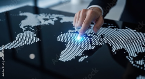 Businessman's finger touching glowing point on futuristic digital world map interface, for global market strategy, international data connection, network expansion, worldwide business