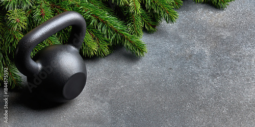 Kettlebell fitness holiday evergreen pine branch concrete background strength training calm fitness holiday scene with evergreen pine branch concrete background, black kettlebell for strength