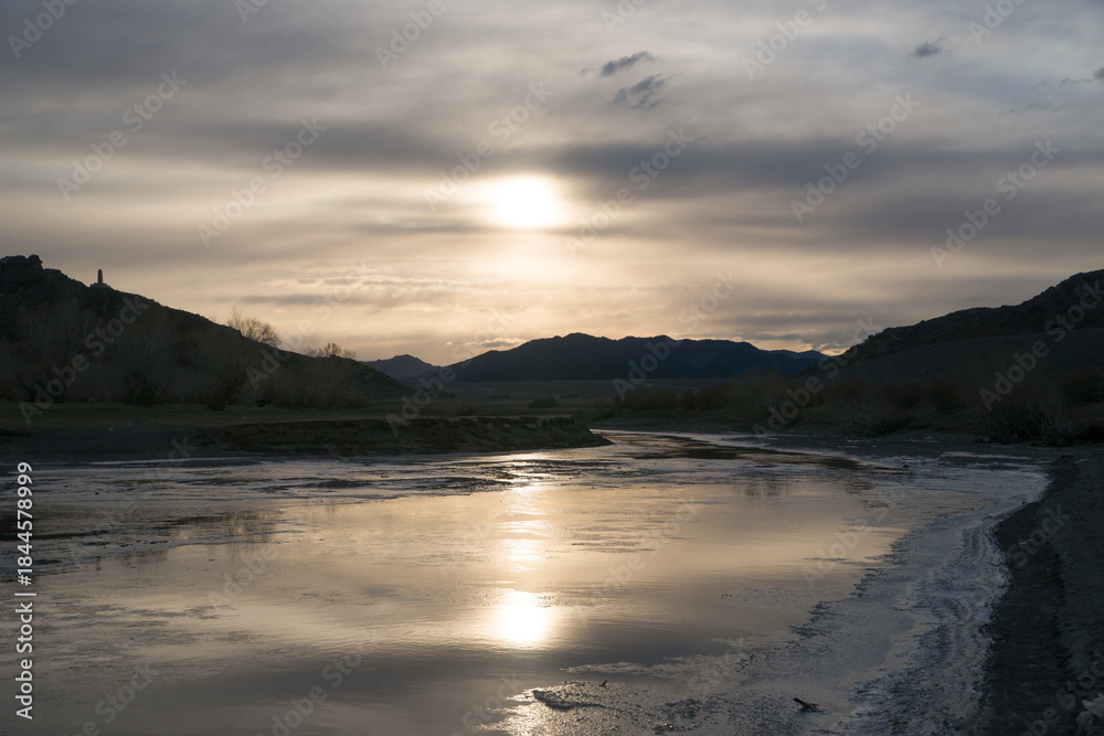 Fototapeta premium Early spring river bank covered in ice