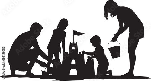 Family building sandcastle together on beach vacation silhouette
