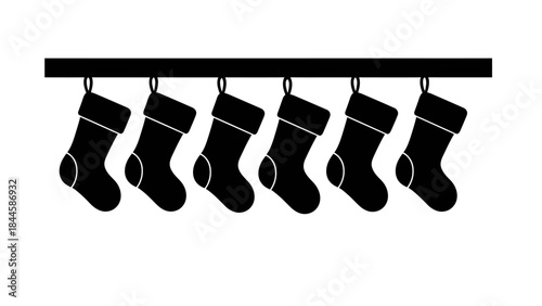 Row of six black christmas stockings hanging on a dark bar against a white background
