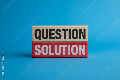 Minimalist image of wooden blocks displaying 'QUESTION' and 'SOLUTION' on a vivid blue background, symbolizing business problem-solving and innovation.