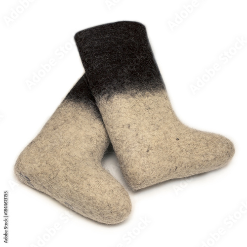 Felt boots with a light bottom and dark top lie on a white background