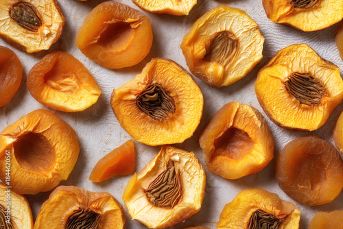A textured background composed of dried peaches and apricots forming a warm food background. Ideal for food packaging, organic branding, or healthy eating concepts.