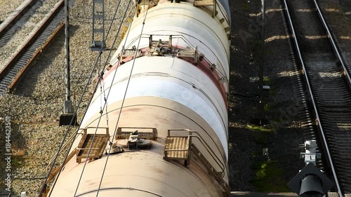 Top view of the railway tracks along which the freight train is moving.
