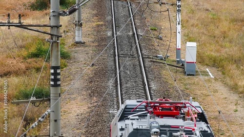 Top view of the railway tracks along which the freight train is moving.
