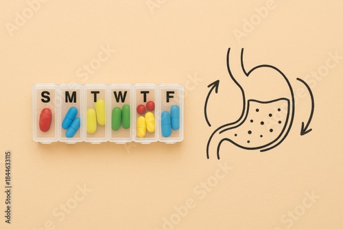 Weekly pill organizer with colorful capsules and stomach doodle on peach background