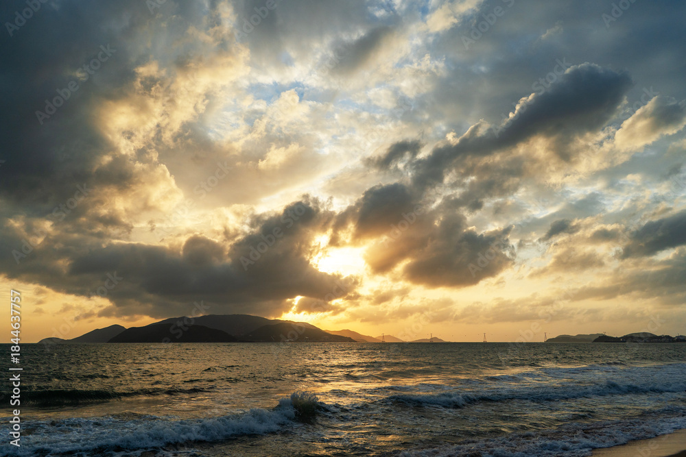 Fototapeta premium Beautiful sunrise over the ocean with dramatic clouds.