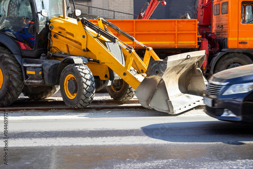 A bulldozer and a dump truck on the road. Repair work.