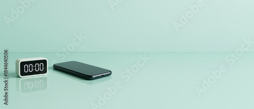 Digital clock and smartphone on pastel green surface, background