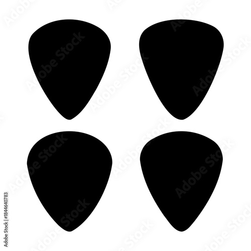 Four black guitar picks, essential musical accessory for play