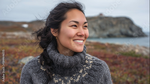 Close up outdoor portrait of smiling Eskimo woman wearing traditional clothes.