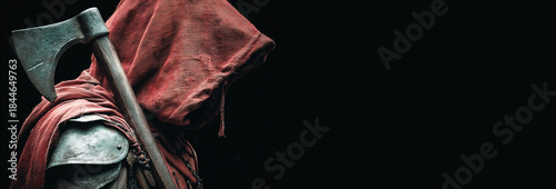 Depiction of a medieval executioner holding an axe in a dark setting with a hooded figure