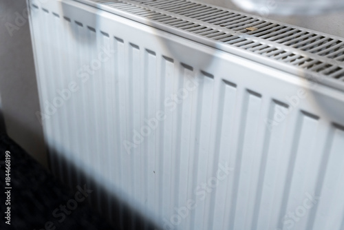 Wallpaper Mural A modern white radiator showcased in a cozy indoor setting, providing warmth and comfort during winter months. Ideal for home improvement, heating solutions or interior design concepts. Torontodigital.ca