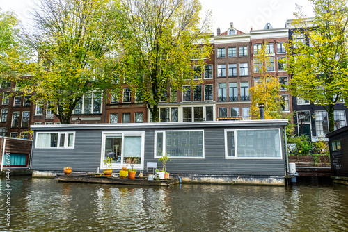 Bild auf Leinwand A floating house in Amsterdam canal. Boat home